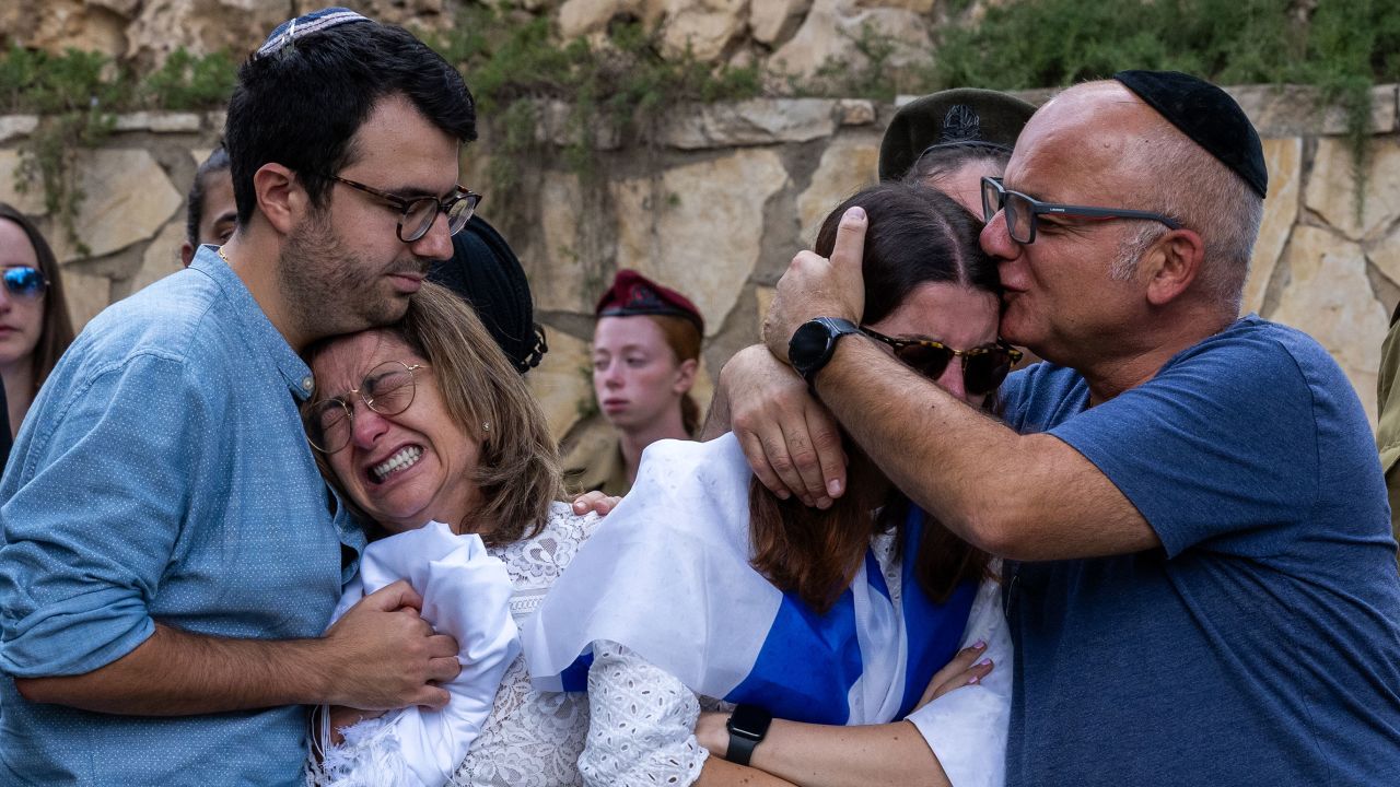 The mother (L), sister (R) and immediate family of Valentin (Eli) Ghnassia, 23, who was killed in a battle with Hamas militants at Kibbutz Be'eeri near the Israeli border with the Gaza Strip, react during his funeral, October 12, 2023 in Jerusalem, Israel.