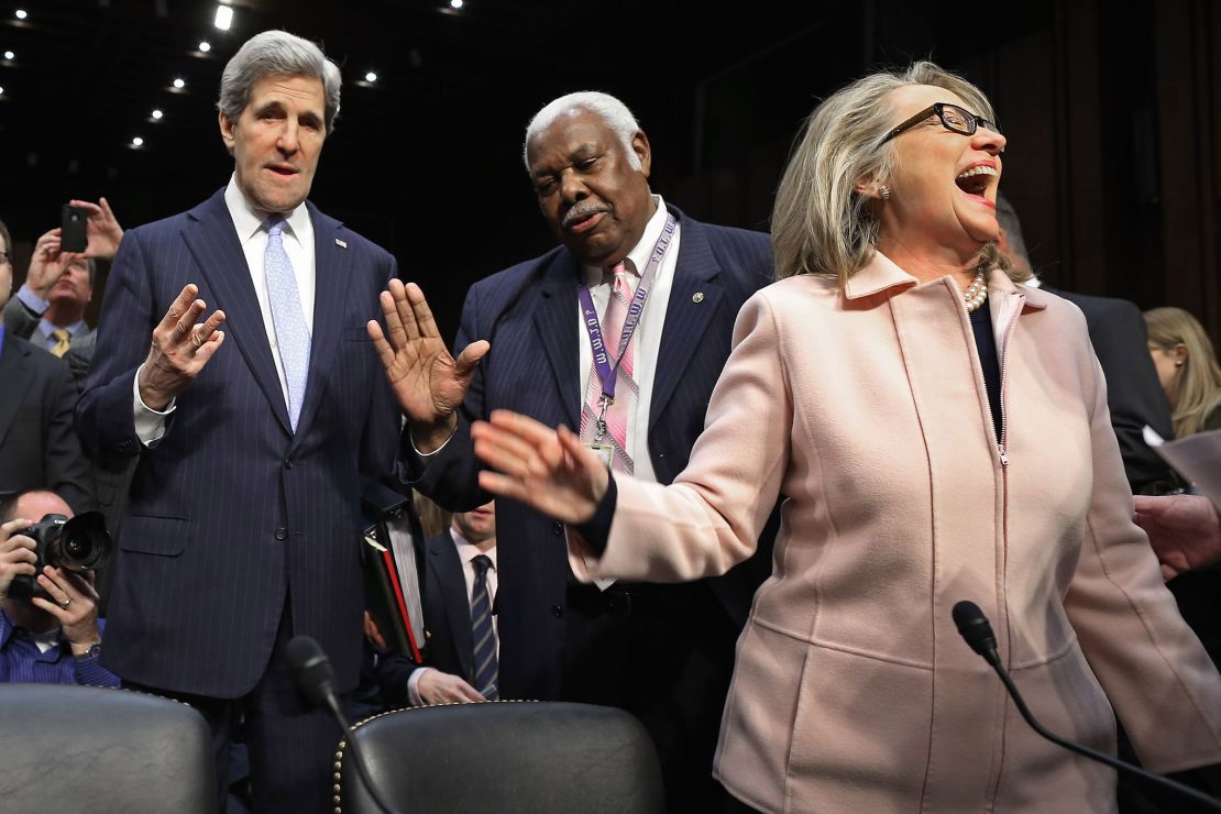 Sen. John Kerry talks with committee staffer Bertie Bowman as US Secretary of State Hillary Clinton has a laugh before Kerry's confirmation hearing before the Senate Foreign Relations Committee to become the next Secretary of State in the Hart Senate Office Building on Capitol Hill January 24, 2013 in Washington, DC.