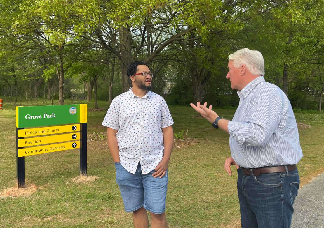 Carey Fulks and John King walk through Grove Park on the outskirts of Atlanta.