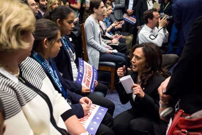 Harris speaks to Fatima and Yuleni Avelica, whose father was deported, before a news conference on Capitol Hill in March 2017.